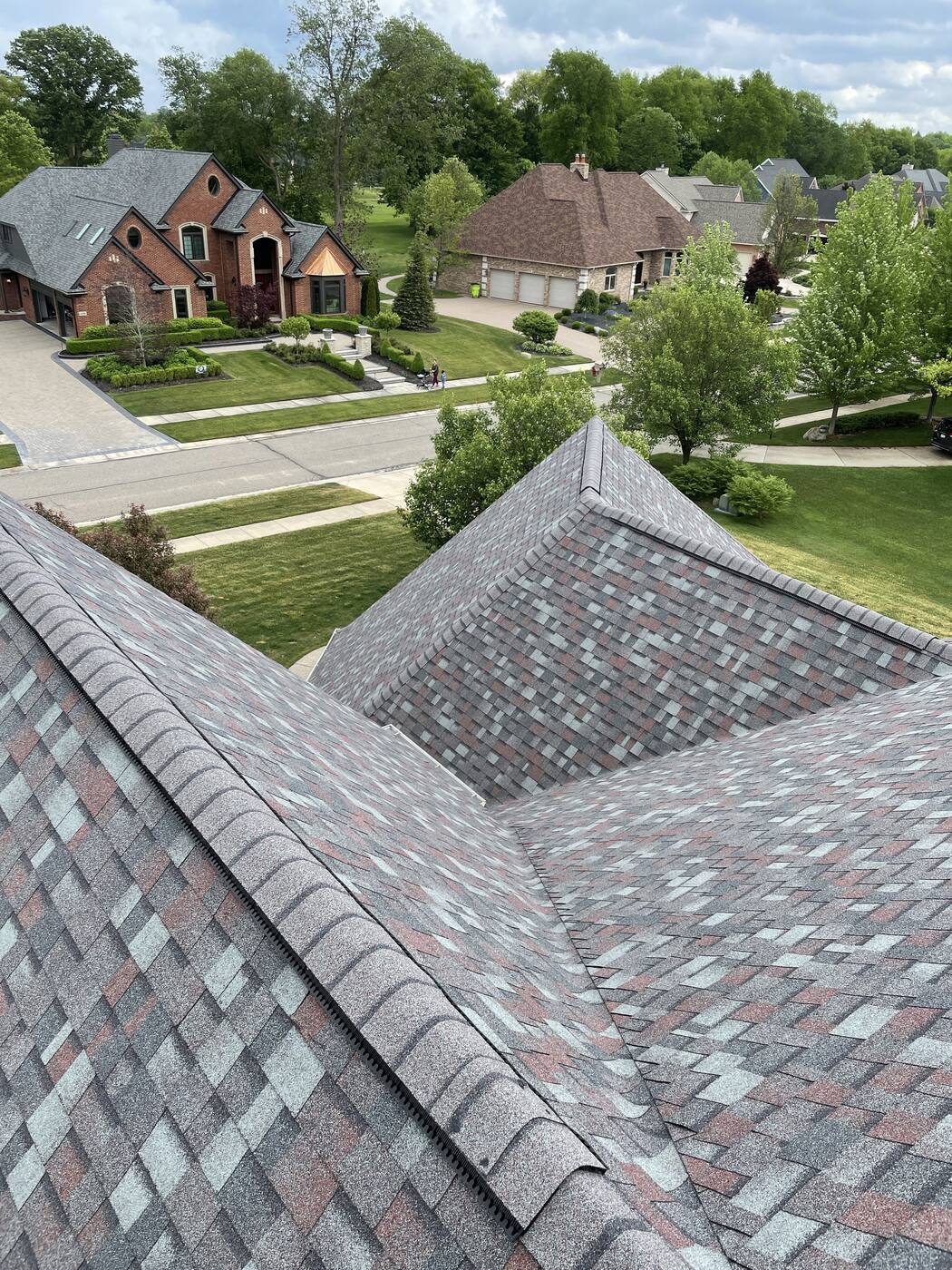 Hip roof and valley detail with the neighborhood behind it