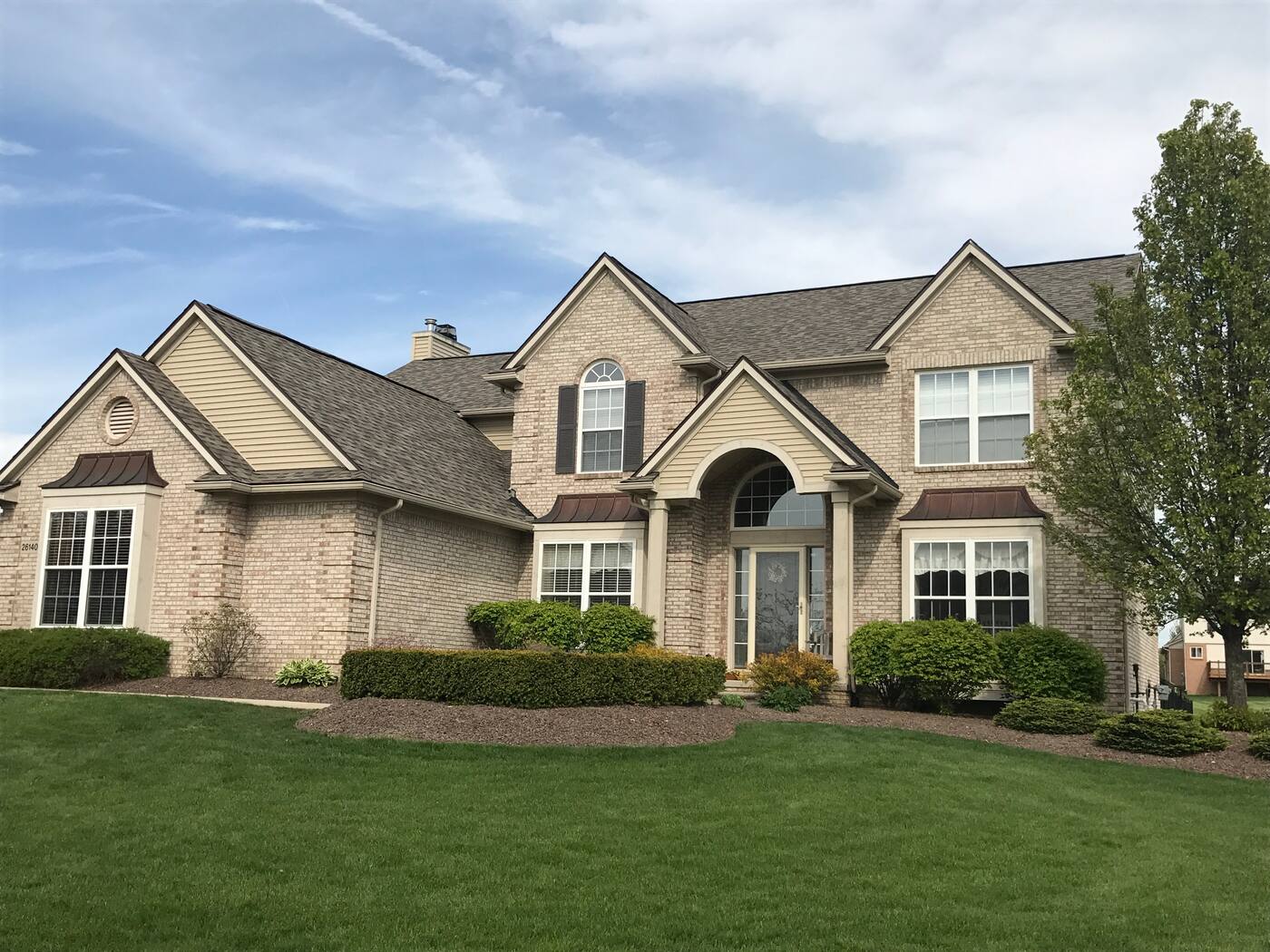 Complete tear-off and architectural shingle replacement on a two-story brick home