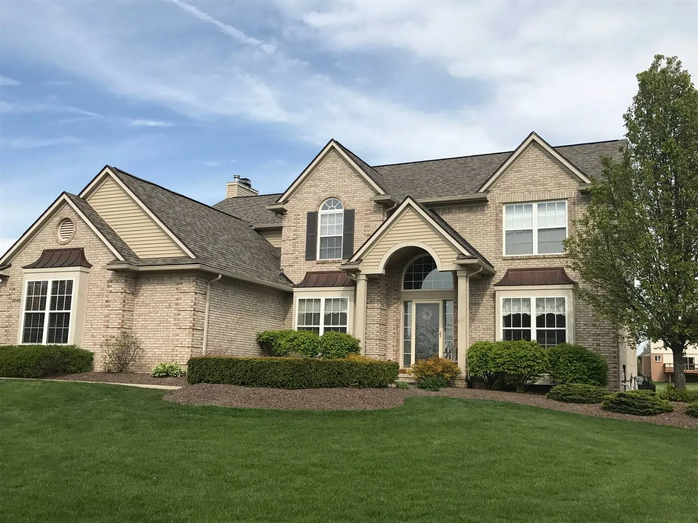 Complete tear-off and architectural shingle replacement on a two-story brick home