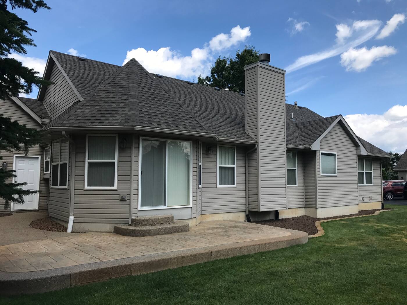 Gray-sided ranch finished with weathered-wood architectural shingles