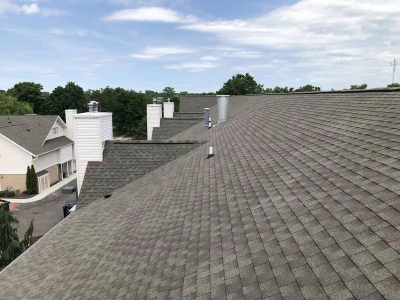 New shingles across a long apartment building ridge