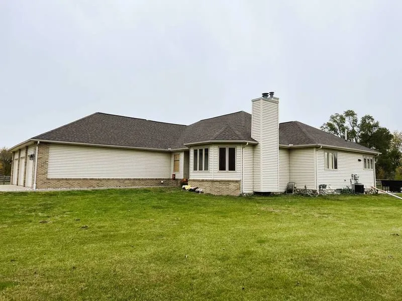 Cream ranch home with a new roof and rebuilt chimney flashing
