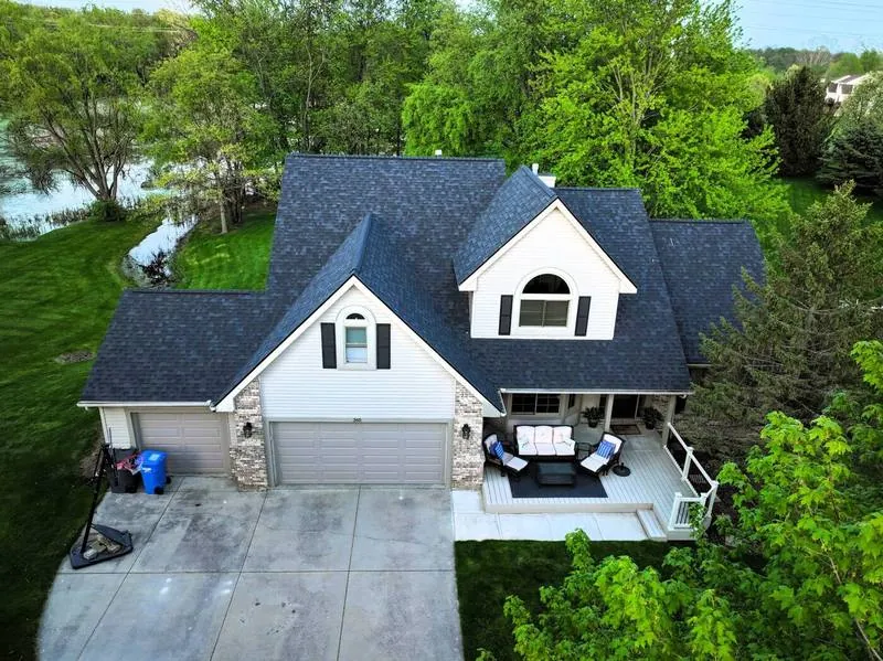 Overhead view of a finished roof on a home with a stone-front garage