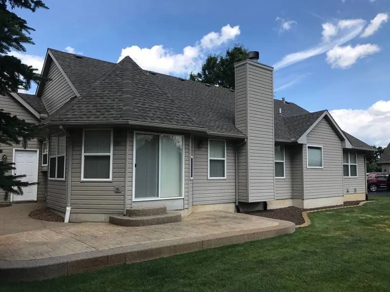 Gray-sided ranch finished with weathered-wood architectural shingles