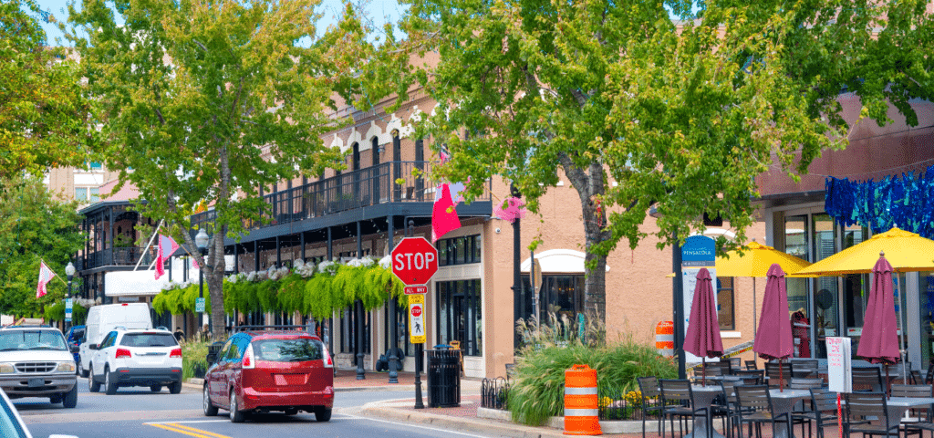 a streetscape of vibrant cars in the summer
