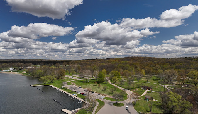 Aerial view of a lakeside park with winding paths