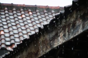 Water droplets fall from the roof of an old house when it rains in the afternoon in tropical areas in Indonesia.